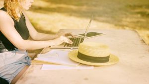 Unrecognizable Female Sitting Desk Working Laptop Outdoors