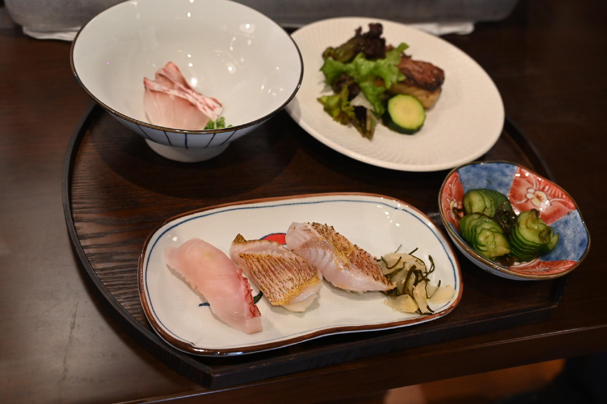 Plates of fresh sashimi and grilled fish served during a December 2025 seafood education workshop in Taitung