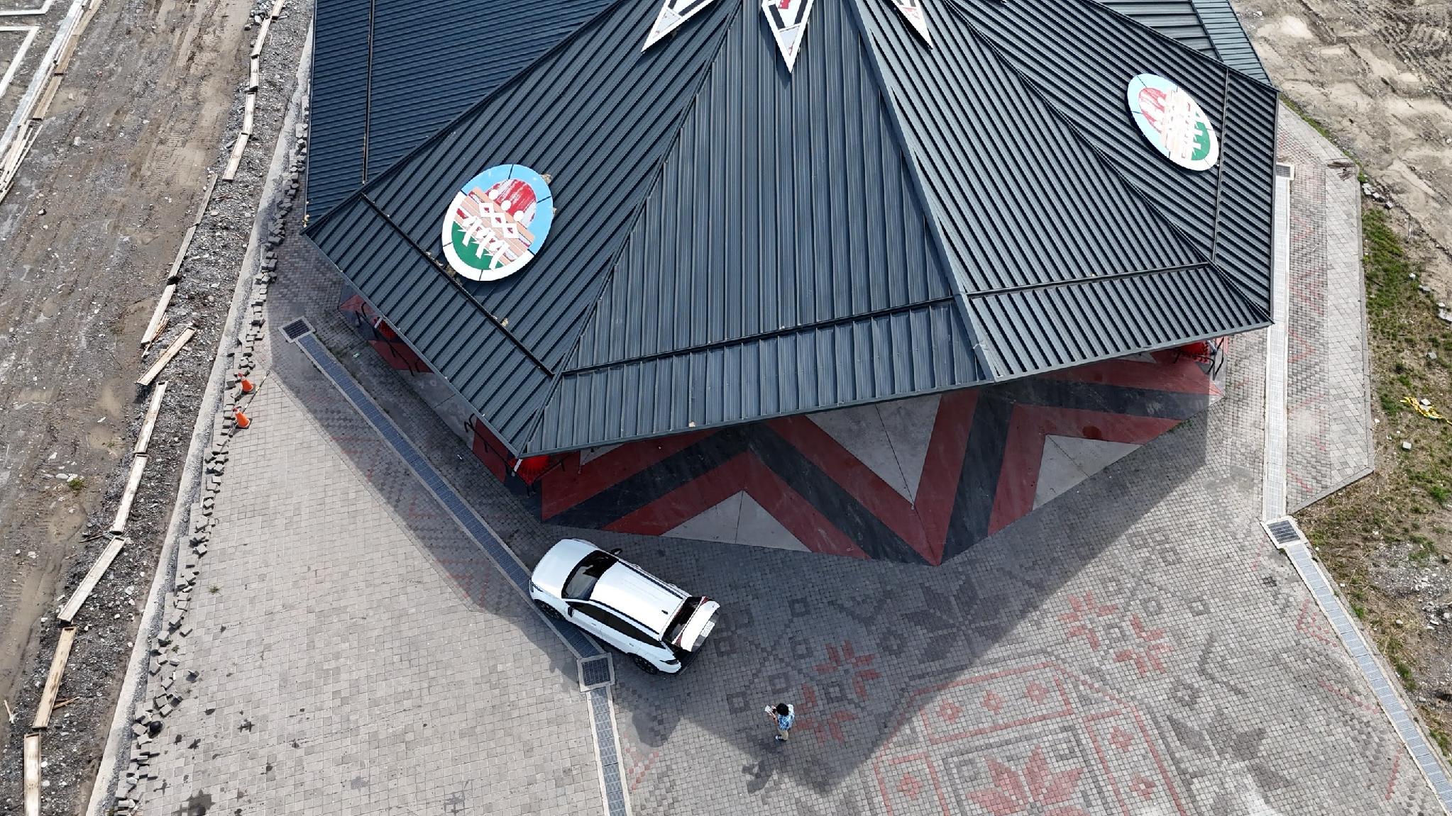 Aerial view of the Matang Indigenous Tribal Gathering Place with a parked car showing the building’s scale, Taitung