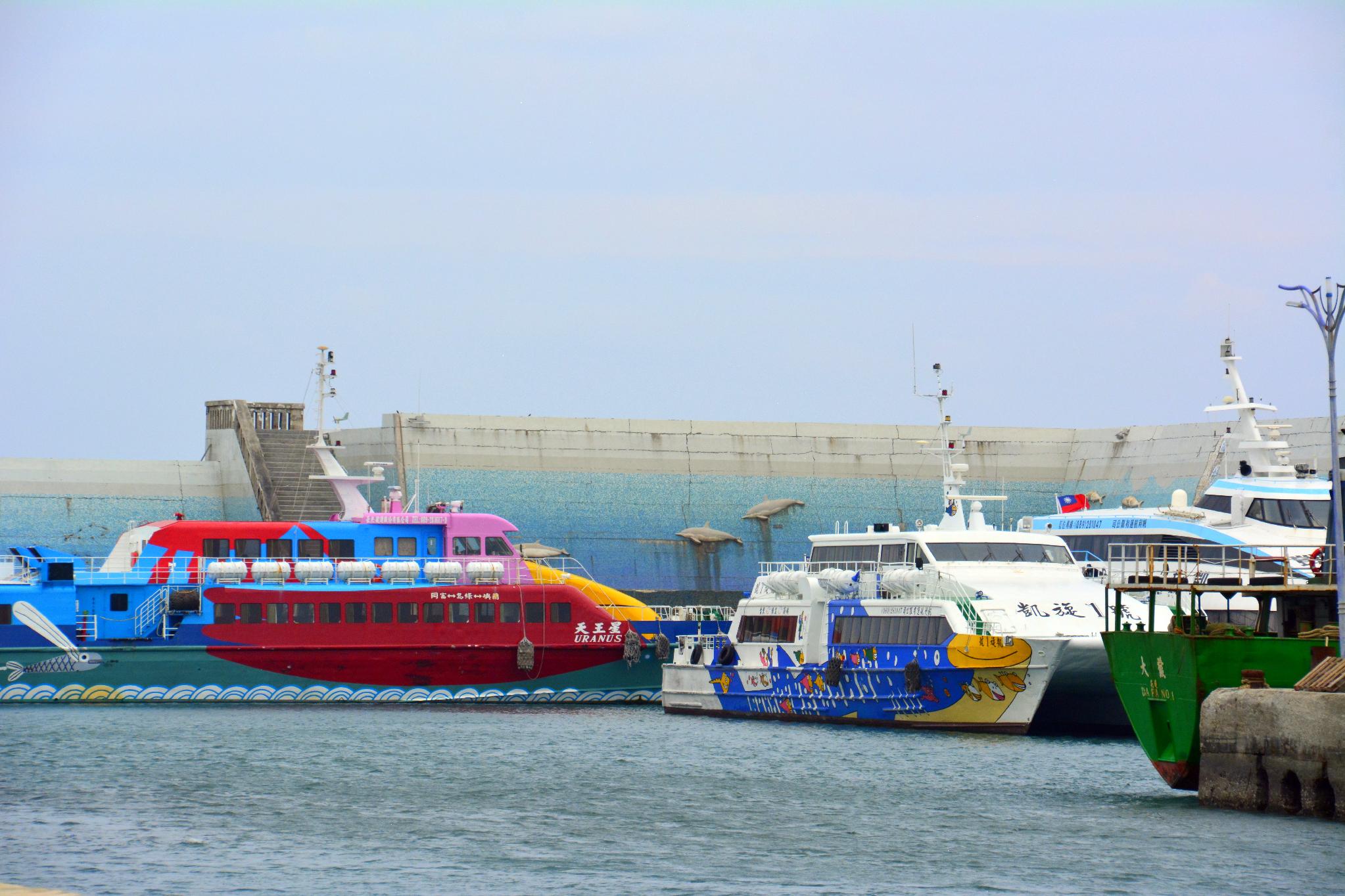Colorful tour boats and ferries moored at Fugang Fishing Harbor, Taitung
