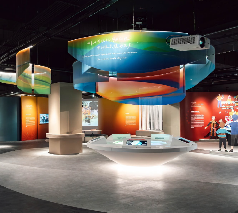 Discover Center of Taitung exhibition hall with suspended colorful ribbon installations and a central interactive display